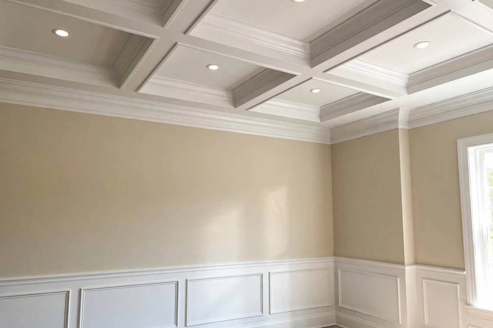 Baseboard fitted along a wall above new flooring in a San Fernando room remodel.