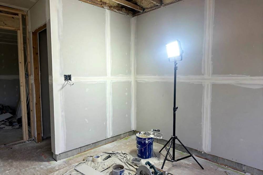 Drywall installation and finishing on a room wall in a San Fernando home remodel.